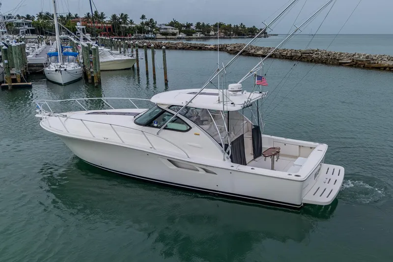 Wahoo Yacht Photos Pics 2009 Tiara Yachts 39 Open in marina, side view, calm waters, American flag displayed.