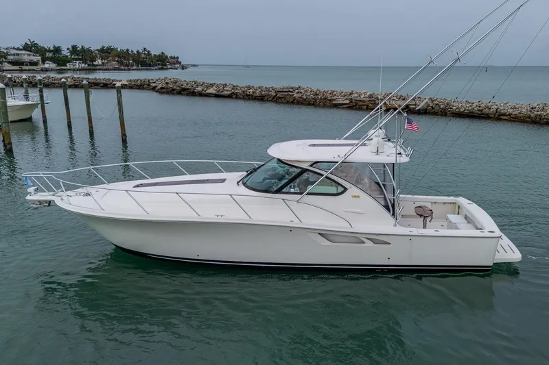 Wahoo Yacht Photos Pics 2009 Tiara Yachts 39 Open cruising in calm waters near a rocky shoreline.