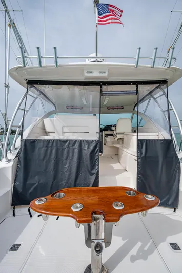 Wahoo Yacht Photos Pics 2009 Tiara Yachts 39 Open with American flag, featuring spacious deck and seating area.