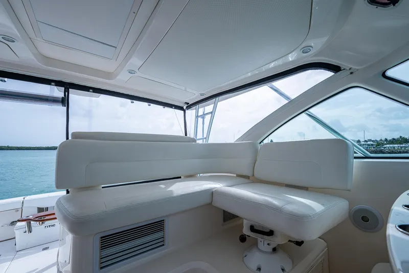 Wahoo Yacht Photos Pics Luxurious interior of 2009 Tiara Yachts 39 Open with white seating and panoramic windows.