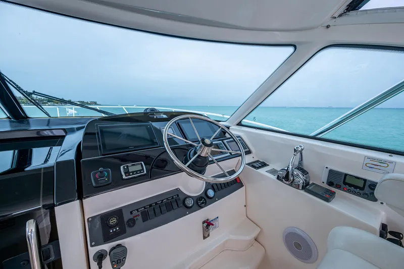Wahoo Yacht Photos Pics 2009 Tiara Yachts 39 Open helm with ocean view, showcasing steering wheel and controls.