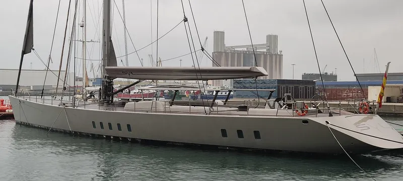 Syl Yacht Photos Pics Sleek 2003 custom SYL sports yacht docked in a marina, overcast sky.