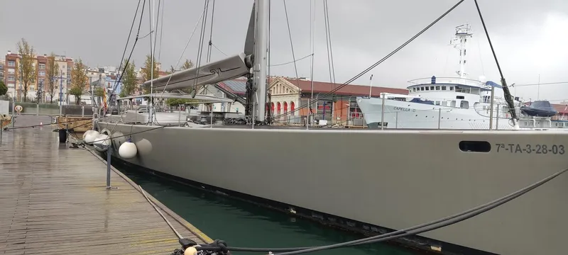 Syl Yacht Photos Pics Sleek 2003 custom sports yacht docked on a rainy day, showcasing modern design.