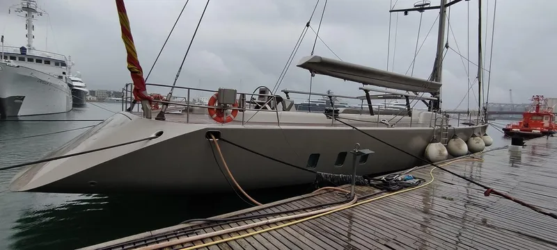 Syl Yacht Photos Pics Sleek 2003 custom sports yacht docked on a rainy day, featuring modern design and equipment.