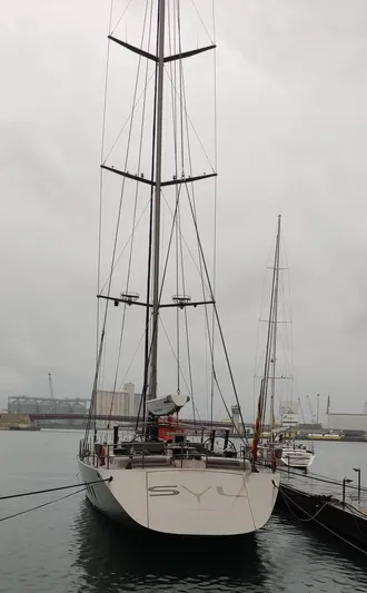 Syl Yacht Photos Pics Sleek 2003 custom sports yacht docked on a cloudy day.