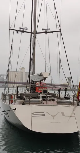 Syl Yacht Photos Pics Sleek 2003 custom SYL sports yacht docked in a marina, overcast sky.