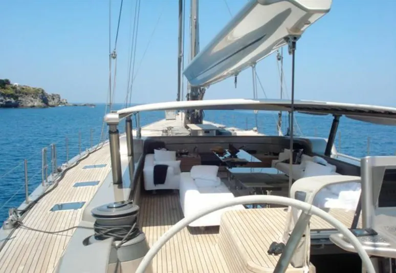 Syl Yacht Photos Pics Luxurious 2003 Custom SYL sailboat with spacious deck and seating, cruising on clear blue waters.