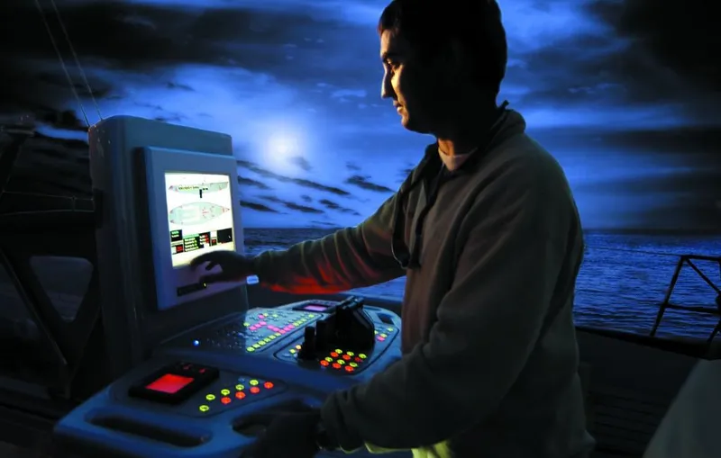 Syl Yacht Photos Pics Person operating a control panel on a 2003 Custom SYL - BARCOS DEPORTIVOS boat at night.