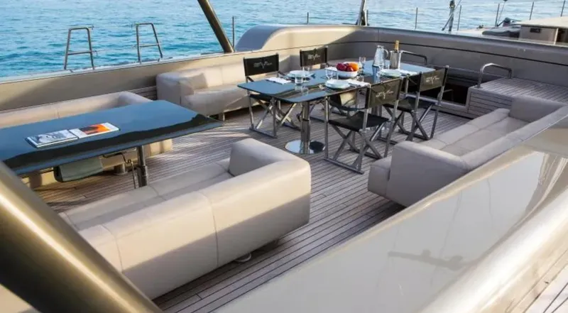 Syl Yacht Photos Pics Luxurious yacht deck with elegant dining setup, modern seating, and ocean view. Custom SYL - BARCOS DEPORTIVOS 2003.