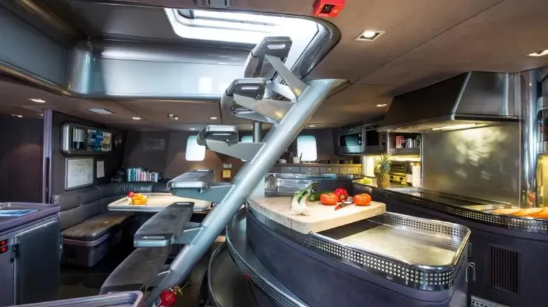 Syl Yacht Photos Pics Luxurious yacht interior with modern kitchen and dining area, featuring sleek design and ambient lighting.