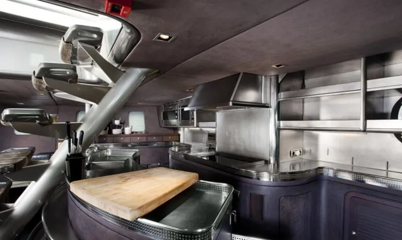 Syl Yacht Photos Pics Modern yacht kitchen interior with stainless steel appliances, sleek design, and wooden cutting board.