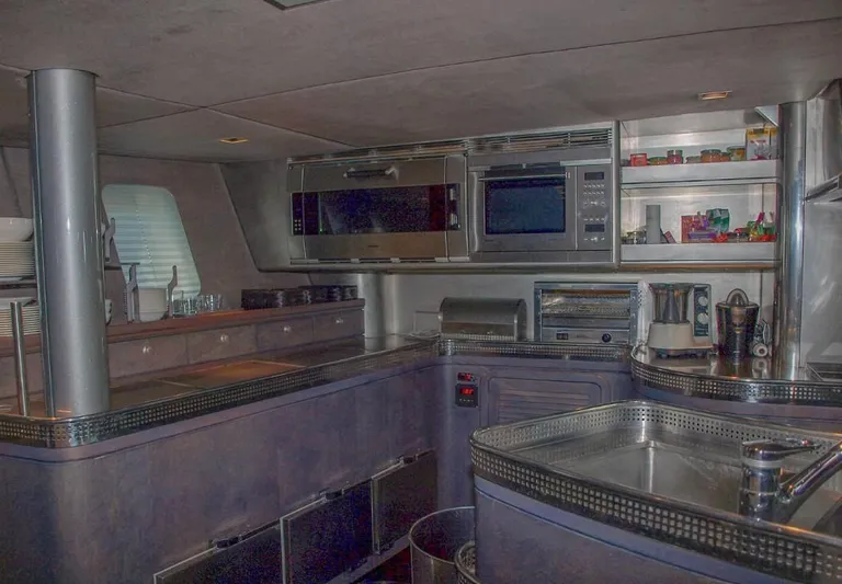 Syl Yacht Photos Pics Luxurious yacht kitchen interior with modern appliances, featuring sleek countertops and ample storage.