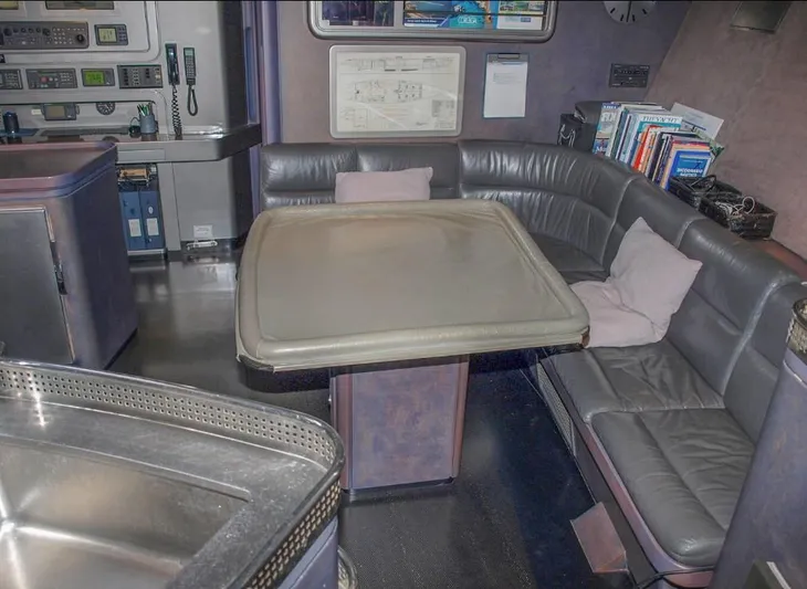 Syl Yacht Photos Pics Luxurious yacht interior with leather seating, table, and navigation equipment, Custom SYL - BARCOS DEPORTIVOS 2003.