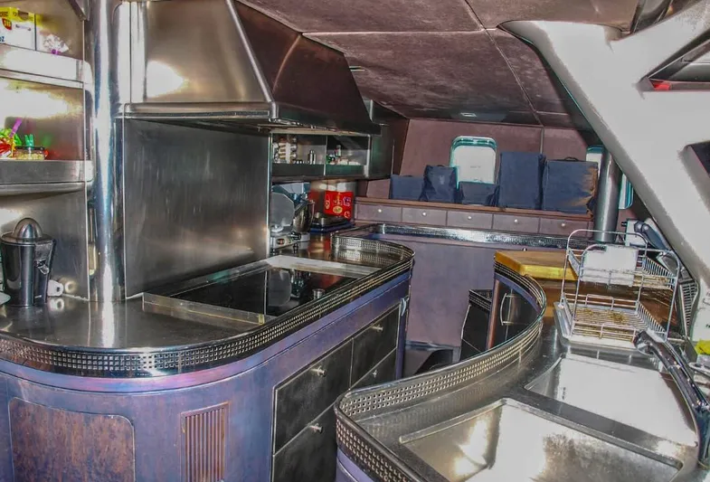 Syl Yacht Photos Pics Luxurious yacht interior with modern kitchen, sleek countertops, and comfortable seating, 2003 Custom SYL model.