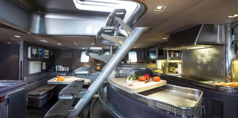 Syl Yacht Photos Pics Luxurious yacht interior with modern kitchen, dining area, and spiral staircase, 2003 Custom SYL model.