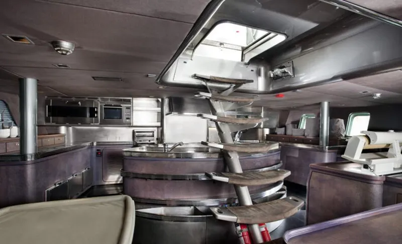 Syl Yacht Photos Pics Interior of 2003 Custom SYL Barcos Deportivos yacht with modern kitchen and spiral staircase.