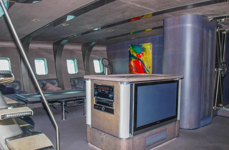 Syl Yacht Photos Pics Luxurious yacht interior with modern design, featuring a TV, artwork, and sleek furnishings.