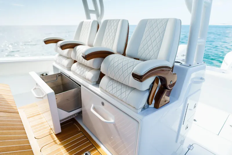 Slowmocean Yacht Photos Pics Luxurious seating on 2021 Barker Boatworks 40 HPC, featuring elegant white upholstery and wooden accents.