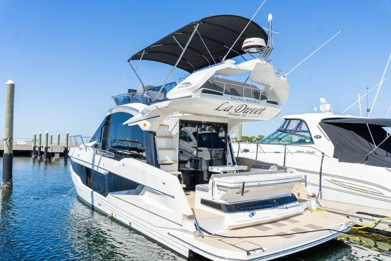  Yacht Photos Pics 2025 Galeon 400 Fly yacht docked at marina under clear blue sky.