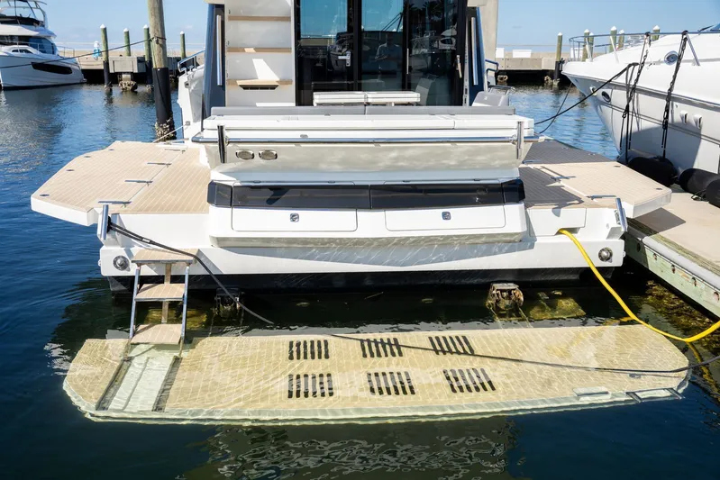  Yacht Photos Pics 2025 Galeon 400 Fly yacht stern view with swim platform and docked at marina.