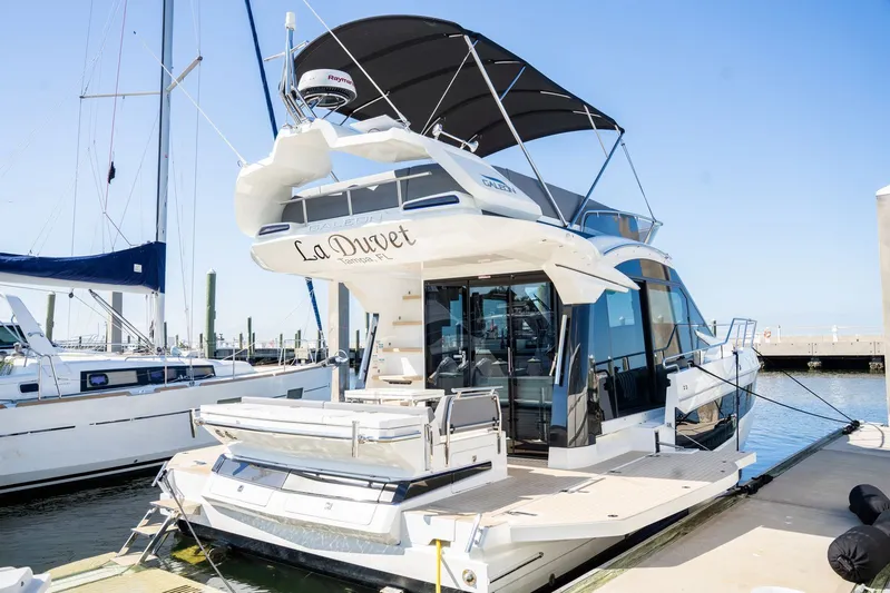  Yacht Photos Pics 2025 Galeon 400 Fly yacht docked at marina, featuring sleek design and spacious deck.