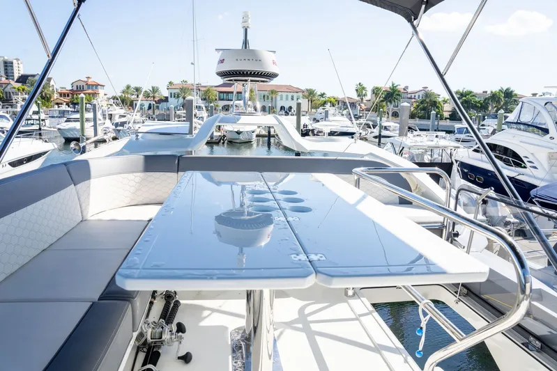 Yacht Photos Pics Luxurious 2025 Galeon 400 Fly yacht interior with marina view, featuring sleek seating and table.