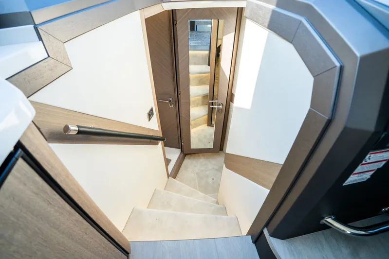  Yacht Photos Pics Staircase inside 2025 Galeon 400 Fly yacht, featuring modern design and wood accents.