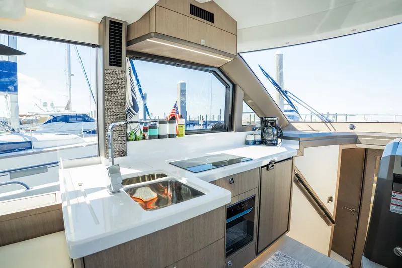 Yacht Photos Pics Modern kitchen interior on 2025 Galeon 400 Fly yacht, featuring sleek design and ample natural light.