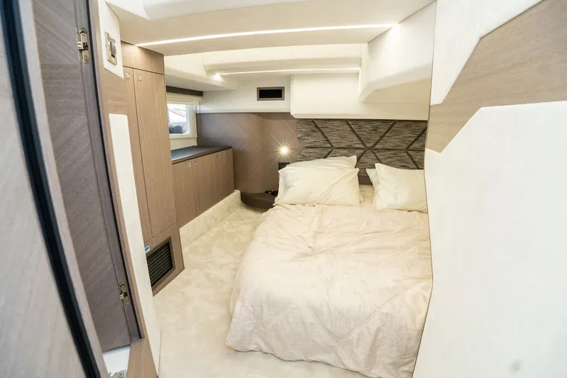  Yacht Photos Pics Luxurious bedroom interior of 2025 Galeon 400 Fly yacht, featuring modern design and cozy bedding.
