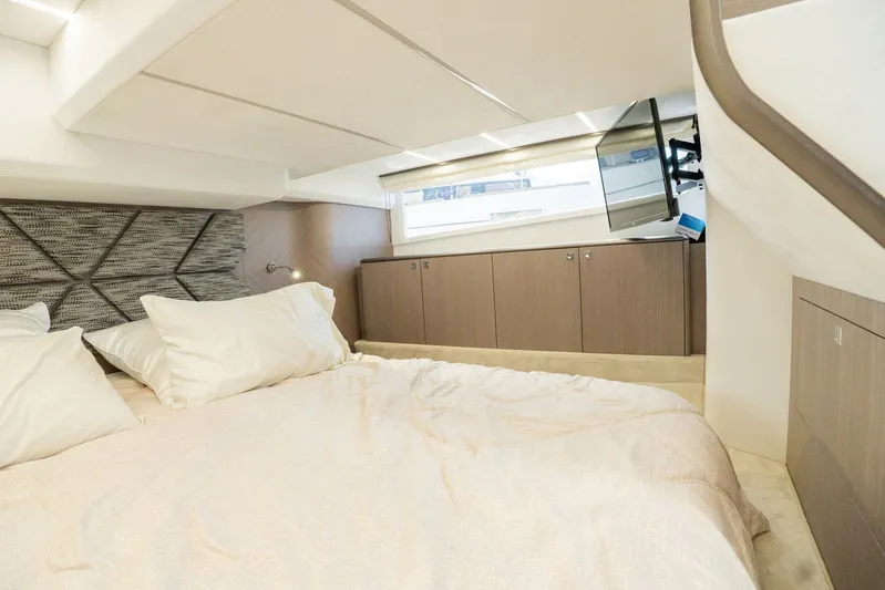  Yacht Photos Pics Luxurious bedroom interior of 2025 Galeon 400 Fly yacht with modern design and TV.