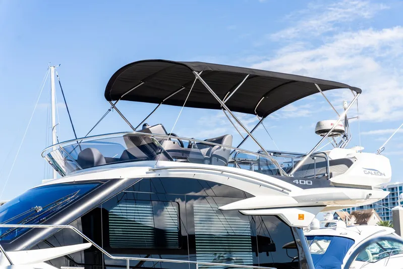  Yacht Photos Pics 2025 Galeon 400 Fly yacht with sleek design and spacious flybridge under a clear blue sky.