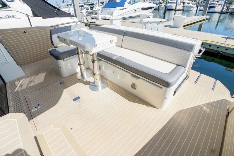  Yacht Photos Pics 2025 Galeon 400 Fly yacht deck with seating and table, docked at marina.