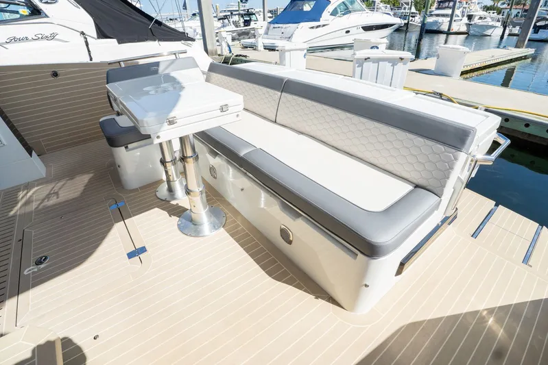  Yacht Photos Pics 2025 Galeon 400 Fly yacht deck with seating and table, docked at marina.