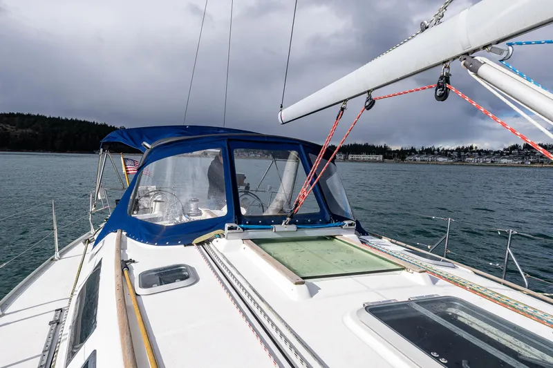 Salus Yacht Photos Pics Jeanneau Sun Odyssey 40 sailboat, 2001 model, on calm waters under cloudy skies.