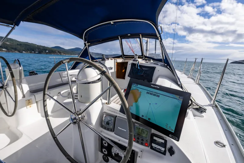 Salus Yacht Photos Pics Cockpit of 2001 Jeanneau Sun Odyssey 40 sailboat with navigation equipment and steering wheel.