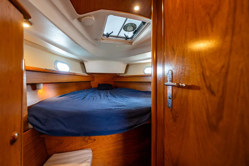 Salus Yacht Photos Pics Cozy cabin interior of 2001 Jeanneau Sun Odyssey 40 sailboat with wooden finish.