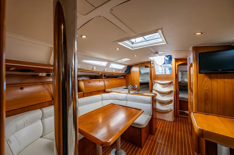 Salus Yacht Photos Pics Interior of 2001 Jeanneau Sun Odyssey 40 yacht, featuring elegant wood finish and comfortable seating.