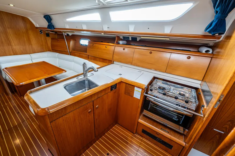 Salus Yacht Photos Pics Interior of 2001 Jeanneau Sun Odyssey 40 yacht with kitchen and dining area.