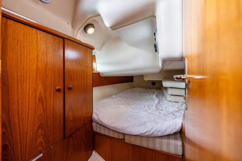 Salus Yacht Photos Pics Cozy cabin interior of 2001 Jeanneau Sun Odyssey 40 sailboat with wooden cabinetry.