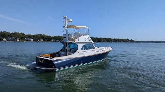 VII Yacht Photos Pics 2007 Hinckley Talaria 44 Flybridge yacht cruising on a calm lake.