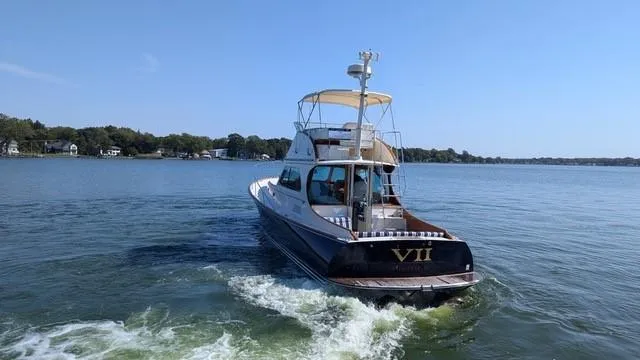 VII Yacht Photos Pics 2007 Hinckley Talaria 44 Flybridge yacht cruising on a calm lake.