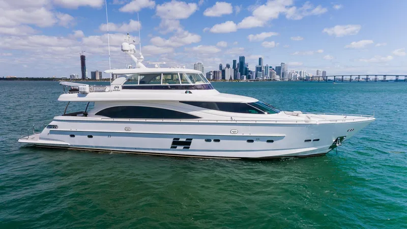 Satori Yacht Photos Pics 2016 Horizon E88 yacht cruising near a city skyline on a sunny day.