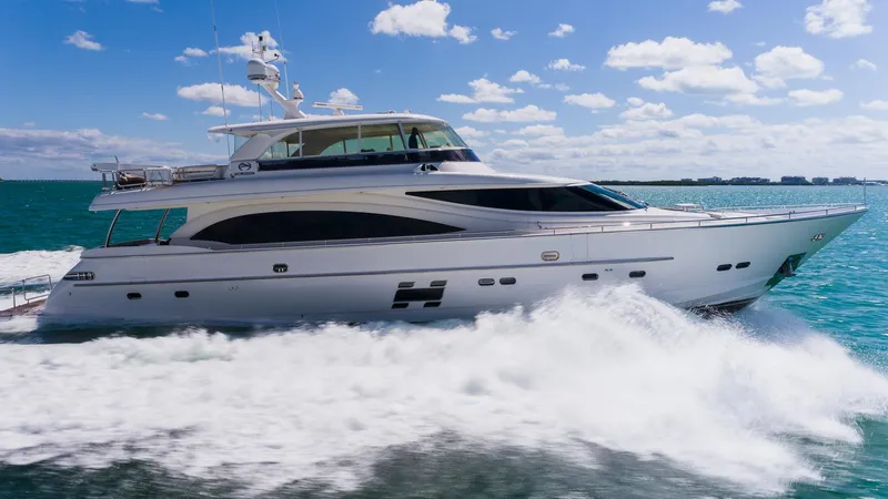 Satori Yacht Photos Pics Luxurious 2016 Horizon E88 yacht cruising on clear blue waters under a sunny sky.