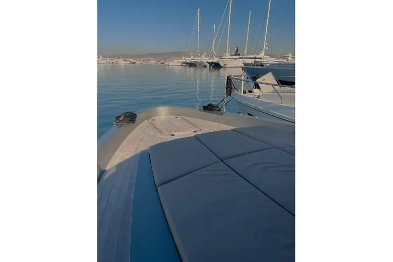  Yacht Photos Pics Luxury Glacier 48 yacht deck in marina, 2023 model, with calm waters and sailboats.