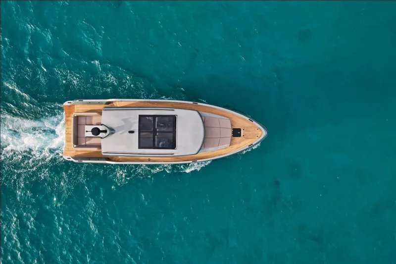  Yacht Photos Pics Aerial view of 2023 Glacier 48 yacht cruising in turquoise waters.