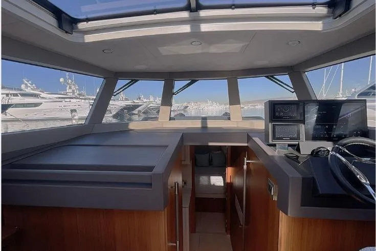  Yacht Photos Pics Interior view of 2023 Glacier 48 yacht, featuring modern helm and panoramic windows.