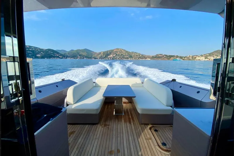  Yacht Photos Pics Luxurious 2023 Glacier 48 yacht cruising with scenic coastal views and elegant seating area.