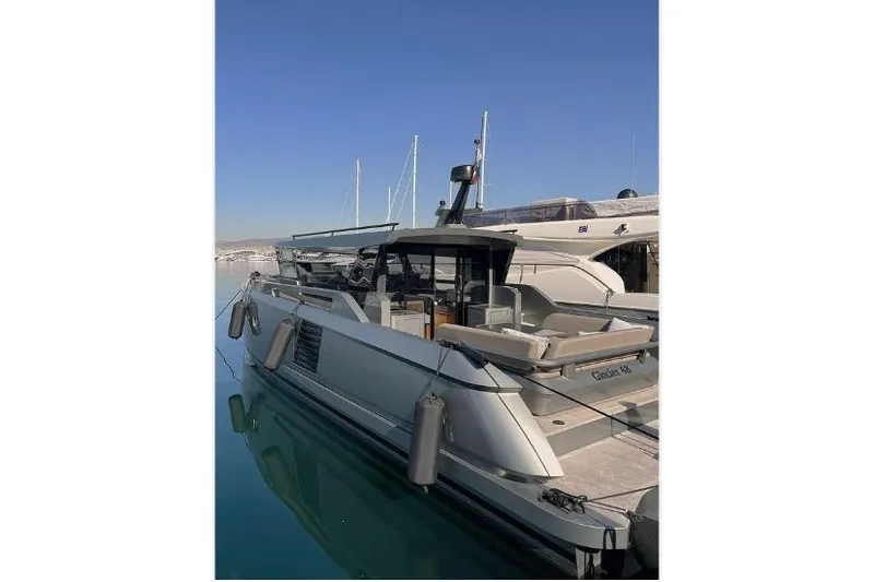  Yacht Photos Pics 2023 Glacier 48 yacht docked in a marina under clear blue skies.