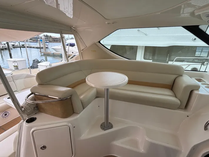 O Sea D Yacht Photos Pics 2008 Tiara Yachts 3900 Sovran interior with curved seating and small table, docked at marina.
