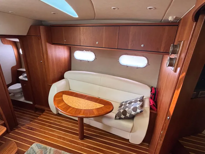 O Sea D Yacht Photos Pics 2008 Tiara Yachts 3900 Sovran interior with wooden cabinetry, white sofa, and oval table.